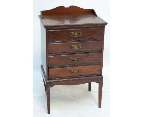 An Edwardian four drawer music cabinet.