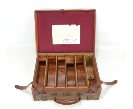 A vintage canvas and leather bound cartridge magazine suitable for 2 3/4" cartridges, bearing traces of trade label to the li