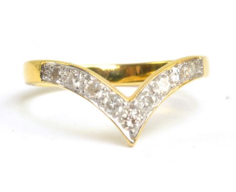 A yellow metal diamond set wishbone ring, size O, approx 2.8g.
