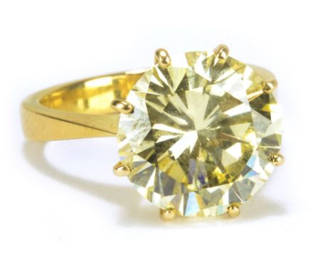 An impressive 18ct yellow gold and fancy light yellow brilliant cut diamond solitaire ring, the stone weighing approx 7.7cts,