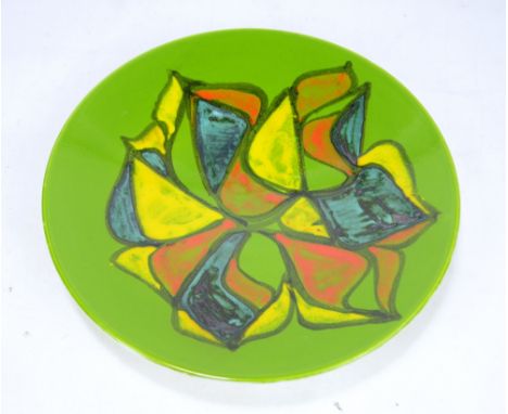 A Poole Pottery 'Delphis' charger with blue, orange and yellow decoration on green ground, printed marks to base, diameter 41