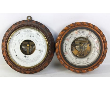 An early 20th century carved oak framed circular barometer set with thermometer, diameter 29cm, and a further oak framed circ