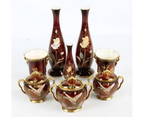 A set of three Carlton Ware twin handled jars with covers painted with floral motifs and ducks, a slender vase, also a pair o