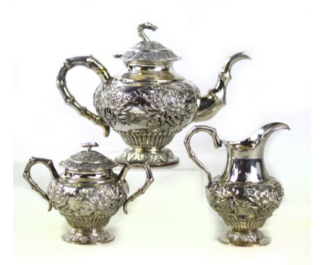 HUNG CHONG; a late 19th/early 20th century Chinese Export silver three piece tea set comprising teapot of squat baluster form