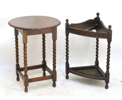 An early 20th century oak occasional table with wrythen twist supports, diameter 56cm, and a stick stand (2).