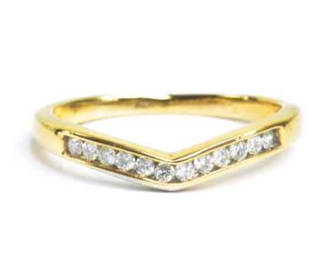 A yellow metal and diamond channel set wishbone ring, approx 1.5g.