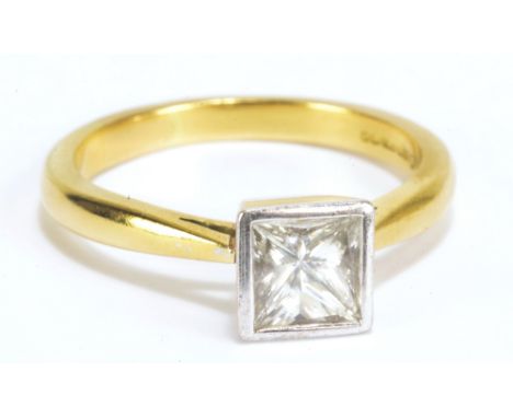 An 18ct yellow gold solitaire diamond ring set with princess cut stone in tapering bezel setting with raised shanks, approx 1