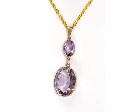 A Victorian two stone oval cut amethyst pendant in 9ct yellow gold mount, length approx 5cm, on modern gold plated chain.