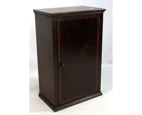 A mahogany table top cabinet, the crossbanded single door enclosing single shelf, 49 x 31cm. CONDITION REPORT: Wear and tear 