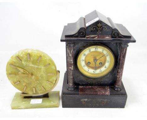 A late Victorian black slate mantel clock of architectural form, the ceramic chapter ring set with Arabic numerals and stampe