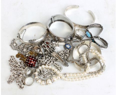 A quantity of silver jewellery including an engraved hinged snap bangle, three further bracelets, chains, brooches, rings, et