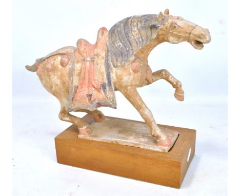 A Tang style ceramic horse on plinth base, height 25cm.