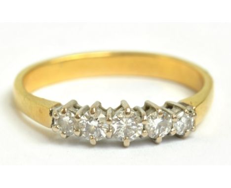 A yellow metal five stone diamond ring, the largest stone weighing approx 0.10cts, size Q 1/2, approx 3.4g.