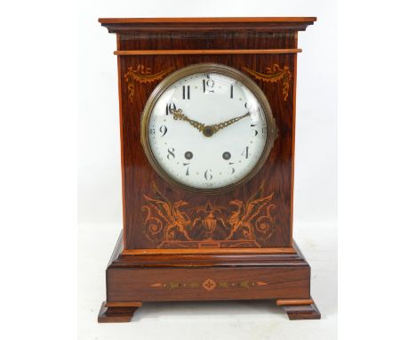 An Edwardian rosewood and inlaid eight day mantel clock with French movement, circular enamel dial set with Arabic numerals a