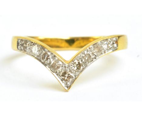 A yellow metal diamond set wishbone ring, size N, approx 2.8g.