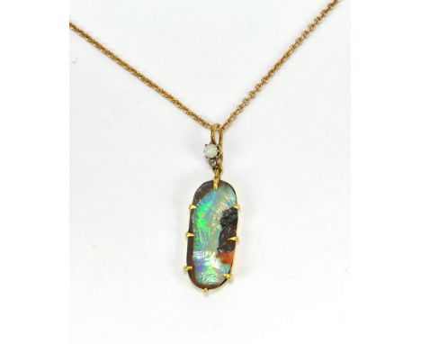 A 19th century oval opal pendant in yellow metal mount with small oval cabochon and diamond chip to loop suspended on yellow 