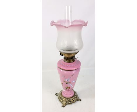 A late Victorian pink opaque glass and enamel painted oil lamp with brass base and associated etched and pink tinted shade, h