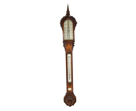 A mid-Victorian oak stick barometer with shaped carved case, arched upper dial inscribed 'JH Steward, 406 Strand, London', wi