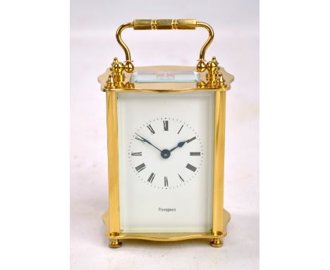 A brass cased carriage clock, the circular dial with Roman numerals and stamped Finnigans below, stamped KJB to reverse, heig
