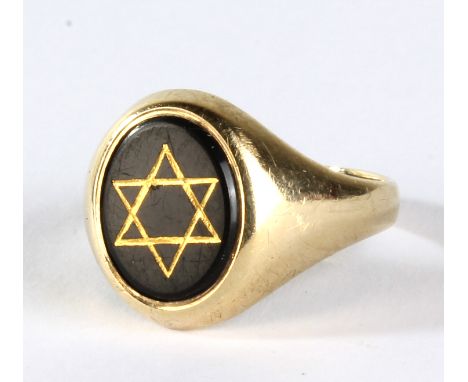 A 9ct yellow gold signet ring decorated with the Star of David to an onyx platform, ring size R 1/2, approx 4.2g.