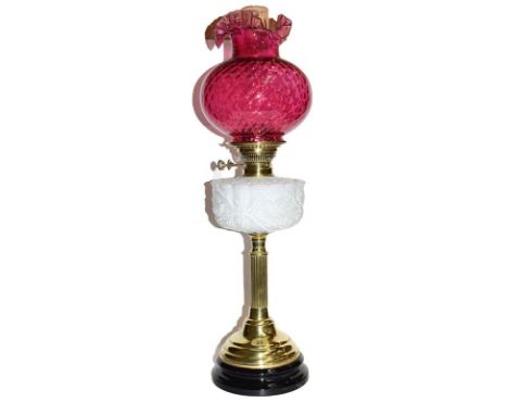 Brass table till lamp with opaline embossed oil well and cranberry shade