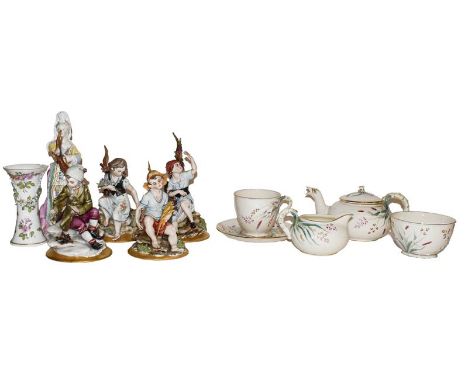 A Belleek bachelors teaset, black printed mark, a German porcelain figure of a maiden together with a set of four Capodimonte