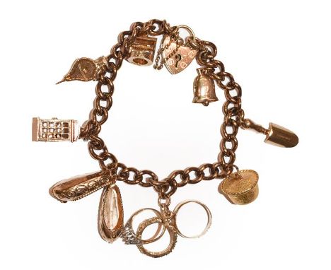 A 9 carat gold curb link bracelet, hung with various charms including a telephone box, a trowel, a bell etc, length 18cm .  G