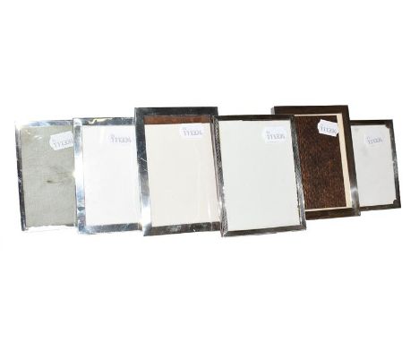A collection of Six Various Silver-Mounted Photograph-Frames, each oblong, four plain and two with differing engine-turned de