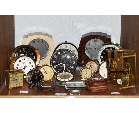 A circa 1950s Bakelite mantle timepiece, together with another identical in white, with fifteen other various alarm clocks da