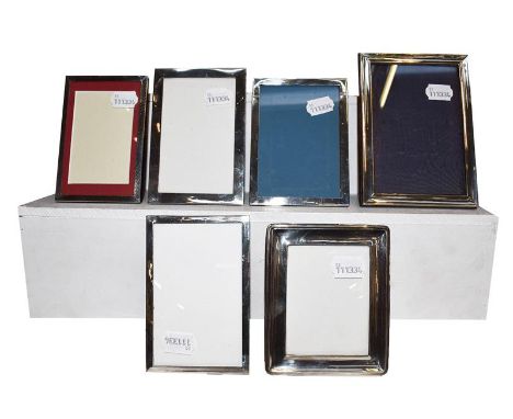 A collection of Six Various Silver-Mounted Photograph-Frames, each oblong, one with engine-turned decoration, the others plai