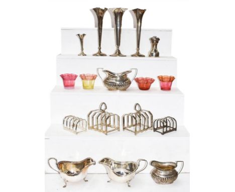 A collection of assorted silver, including: a pair of sauceboats; four various five-bar toastracks; a cream-jug and sugar-bow