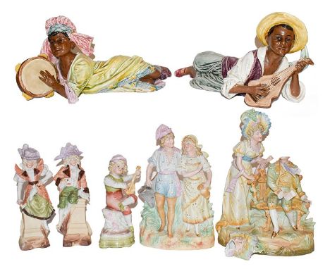 A pair of Goldschieder style figures of reclining Caribbean musicians (a.f.); together with a group of Continental bisque and
