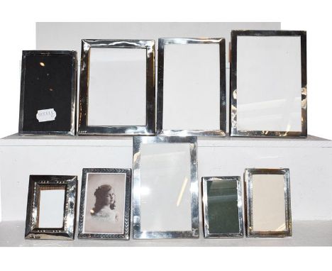 A collection of Nine Various Silver-Mounted Photograph-Frames, each oblong, mostly plain, though two with engine turned decor