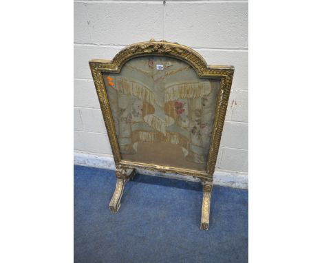 A LOUIS XVI GILT WOOD FIRE SCREEN, with ribbon details to both sides, encasing a later tapestry, raised on splayed legs, widt