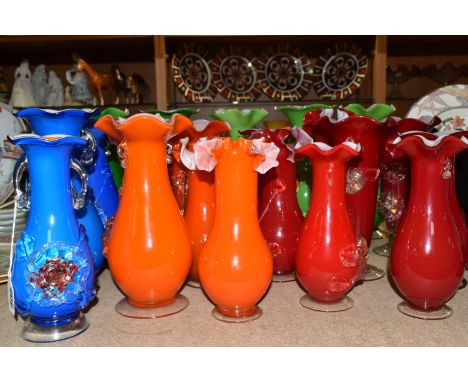 A GROUP OF TWENTY ONE COVERED ART GLASS VASES to include five green, three blue, five orange, eight red, in a variety of size