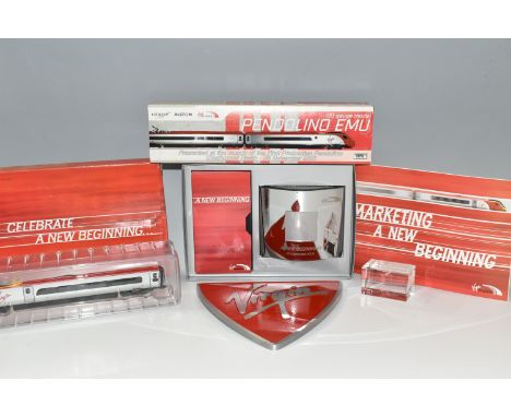 A BOX OF VIRGIN TRAINS RELATED ITEMS, comprising a shield shaped metal plaque, a boxed 00 gauge model of a Pendolino Emu trai