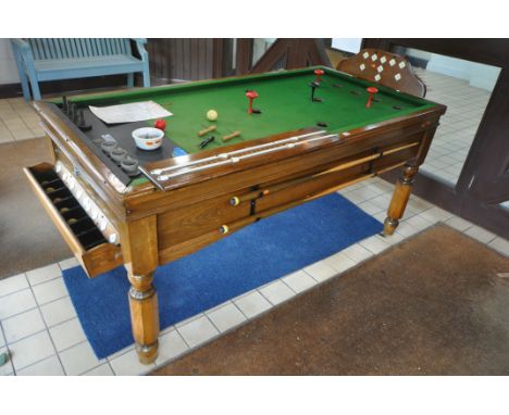 A 20TH CENTURY OAK COIN OPERATED SLATE BED BAR BILLIARDS TABLE, the hinged playing surface enclosing all the inner workings a