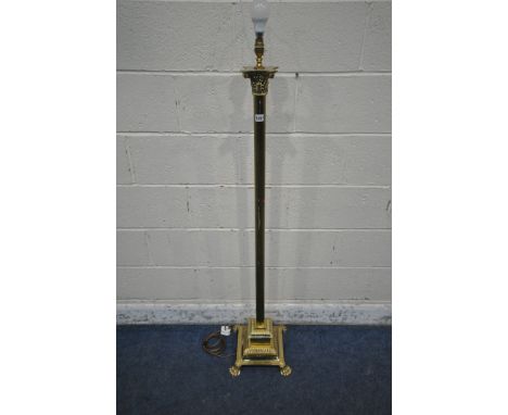 A BRASS CORINTHIAN PILLAR STYLE STANDARD LAMP, with a stepped base, raised on paw feet, height 142cm (condition report: white