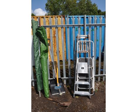 A SELECTION OF GARDEN ITEMS including a rotary clothes line, a parasol, a wooden and two metal step ladders, etc