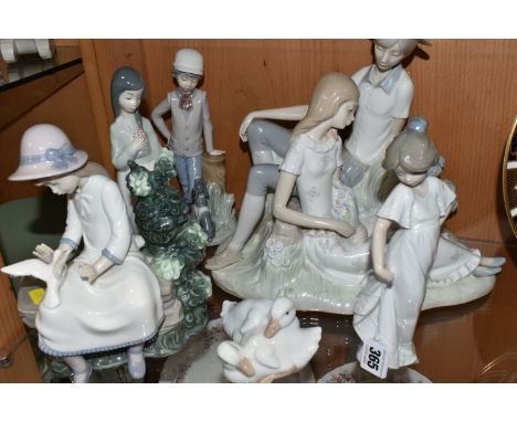 SIX NAO FIGURES, comprising a large figure group depicting a couple seated in the countryside, height 29cm x width 30cm, a gi