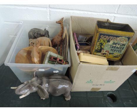 Two boxes of miscellaneous including treen model animals, toy volt meter etc