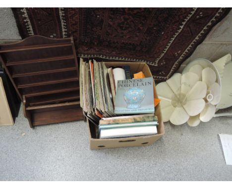 A selection of miscellaneous including wall shelves, lamp shades, books, records and ironing board