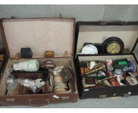 Two vintage suitcases of miscellaneous including brass candlestick, beer mats, barometer, glass, bookends etc
