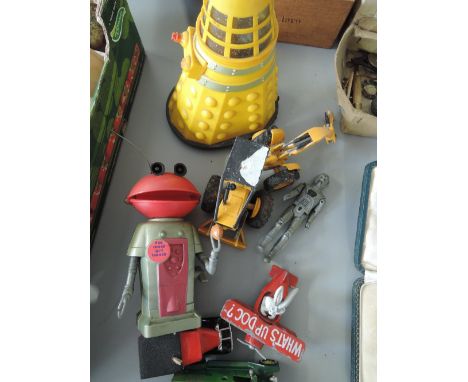 A selection of vintage toys, including Dalek's, Smash TV robot, Bugs Bunny plane, etc