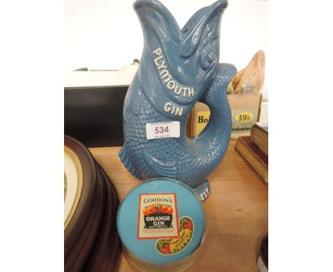 A Plymouth Gin jug, modelled as a fish and a set of cocktail theme coasters