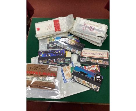 Stamps; Great Britain presentation packs containing over £115 in mint decimal commemorative stamps, plus over 90 first day co
