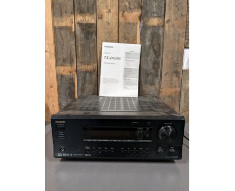 A Onkyo AV receiver, TX-DS595, with manual and a selection of speaker cables 