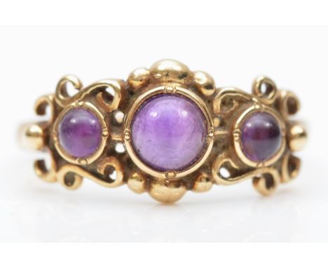 A 9ct gold three cabochon cut amethyst ring, O, 2.5gm 