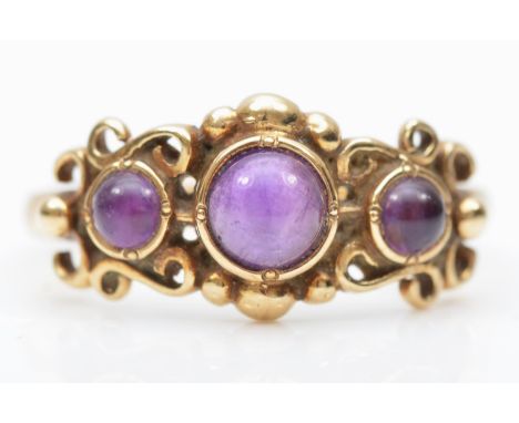 A 9ct gold three cabochon cut amethyst ring, O, 2.5gm 