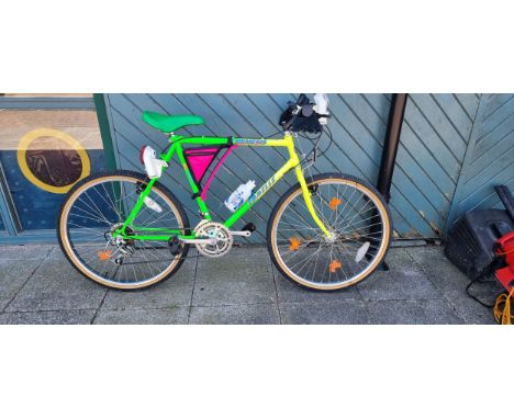 An Emmelle Nemesis push bike, with 6 gears, speedo, headlamp, detachable bag, in graduated neon green yellow colour way, 26 i